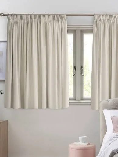 Neutral wave curtains softening a Dubai interior